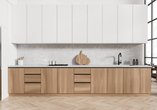 istock White and wooden home kitchen interior with cabinet, dining table near window 2191822393