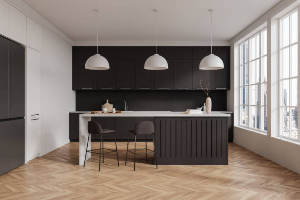 istock Modern kitchen interior with dark cabinets, island, and bar stools in a bright room with large windows. 3D Rendering 2191822792
