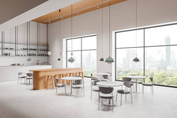 istock Modern cafe interior with island, dining tables in row and panoramic window 2191824216