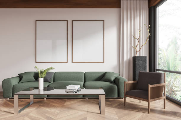 istock Two empty framed posters on a modern living room wall with green sofa and wooden flooring. 3D Rendering 2191824488