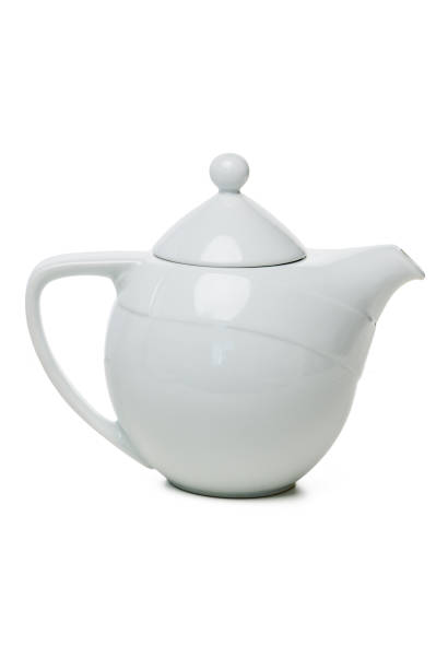 istock Elegant white teapot resting on a wooden surface, perfect for serving tea in a cozy setting 2191825053