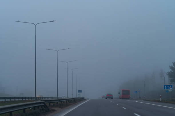 Traffic on the highway during thick morning fog. Road Safety Week. UN GLOBAL ROAD SAFETY WEEK. European Day of Awareness for road safety. ROADPOL Safety Days. Road Day 20 tráfico en la autopista durante la espesa niebla matutina. semana de la seguridad vial. semana mundial de las naciones unidas para la seguridad vial. día europeo de concienciación sobre la seguridad vial. jornadas de seguridad roadpol. día de la seguri