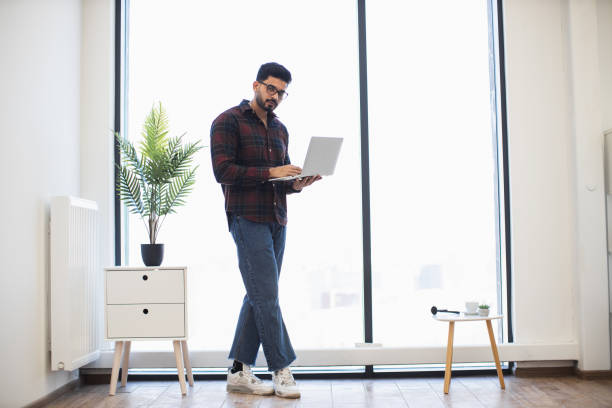 istock Confident young man working on laptop in modern office 2191828026