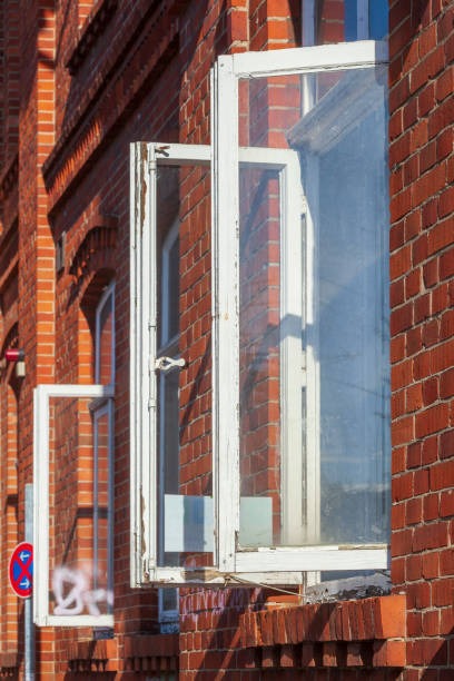 istock Old white wooden shutter on an open window of a red brick building, Lower Saxony, Germany 2191832240