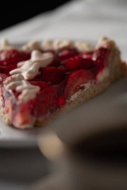 A slice of strawberry cake with cream and gelatin.