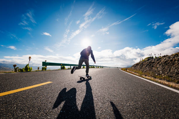 istock Skateboarder skateboarding on the mountain road 2191837733