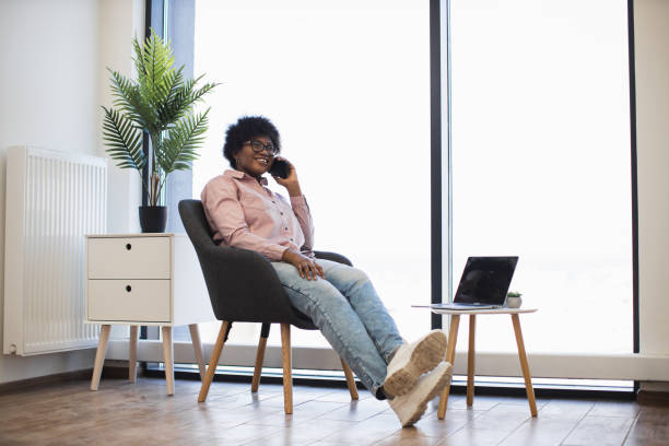 istock Relaxed businesswoman on phone call in modern office setting 2191839119