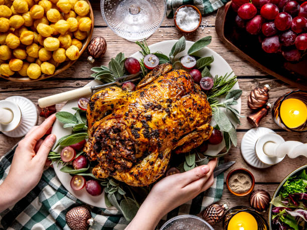 istock female hands placing the tray with roasted chicken on the festive table 2191840643