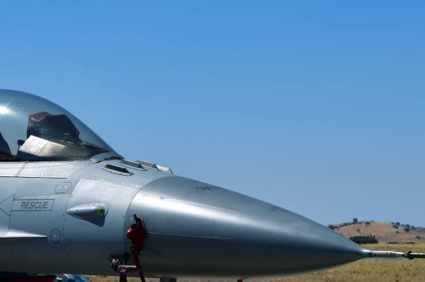 Four antenna pods of an 'Identification Friend or Foe' (IFF) system. The IFF is an electronic equipment used by military aircraft to determine whether other aircraft or systems in the vicinity are friendly or hostile. Its primary purpose is to prevent friendly fire and enhance situational awareness in combat zones, allowing pilots to differentiate between allies, neutral entities, or unknown / enemy contacts. An IFF system typically consists of a transponder and an interrogator. The transponder responds to interrogation signals from other systems, while the interrogator sends out signals to identify aircraft. Operating in multiple modes, including civilian and military, the system often uses encryption for secure communication. When an interrogator sends a radio signal, a compatible transponder on the target aircraft replies with encoded information, such as its identity or status. This response is analyzed to classify the target. However, the IFF system has limitations: it requires both the interrogator and target to have compatible and functional systems, and it does not replace the need for visual identification or other methods of threat assessment in complex scenarios. iff, sistema de identificación amigo o enemigo (4 antenas sobre el morro de la aeronave), rhaws - sistema de alerta y guiado por radar (cerca de la señal de rescate), sensor de ángulo de ataque aoa, tiras de desvío de rayos y tubo de pitot - nariz f16