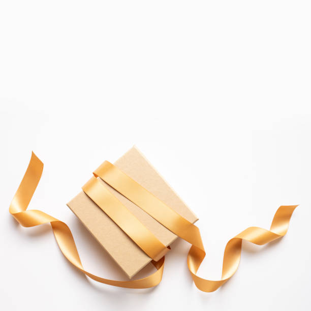 istock Simple gold gift box with stream ribbon decoration for celebration season template design.anniversary and special day with  luxury present 2191842265