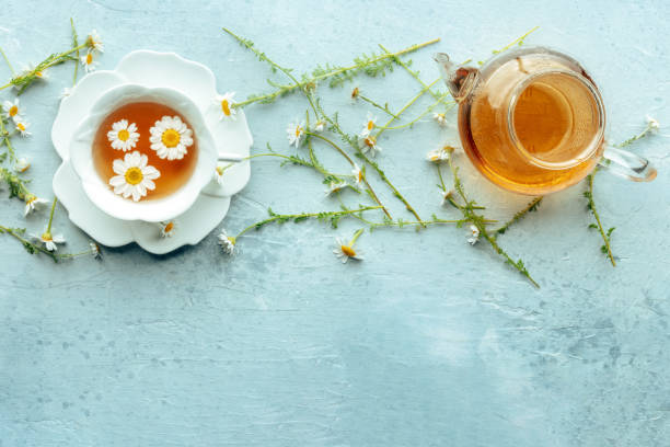 istock Chamomile flower tea. A tea cup and a tea pot with fresh medicinal flowers 2191842339