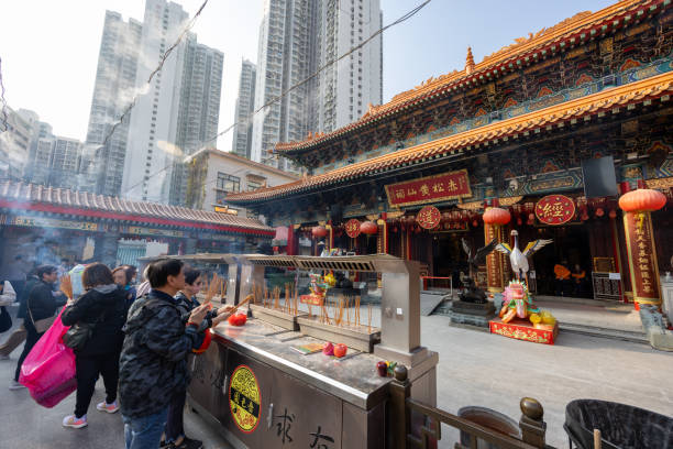 Hong Kong - December 30, 2024 : People at the Wong Tai Sin Temple in Kowloon, Hong Kong. It is a Taoist temple established in 1921. Wong Tai Sin Temple is one of the most famous temples in Hong Kong.