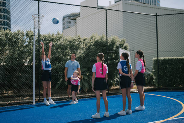 istock Australian coach guiding young netball female team players on routine practice 2191845111