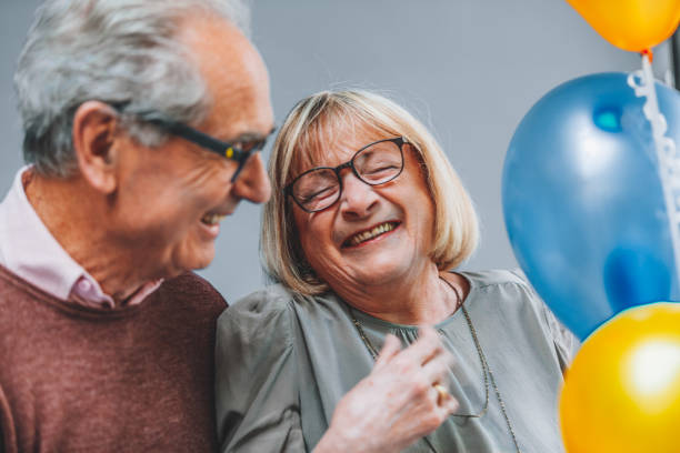istock Joyful Elderly Couple Celebrating with Balloons 2191848279
