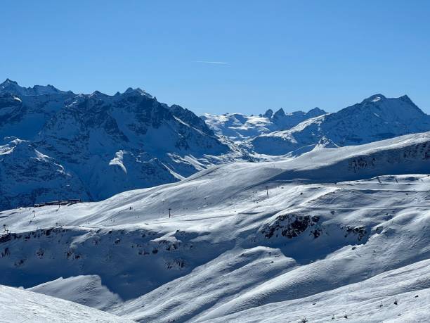 istock Snowy alpine mountains under a clear blue sky. 2191852404