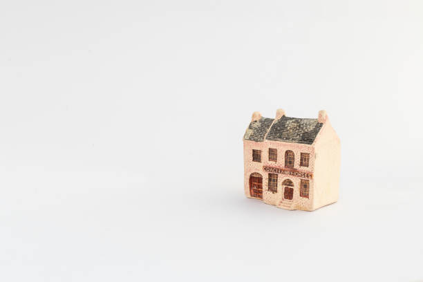 Toy miniature house with stable on white isolated background