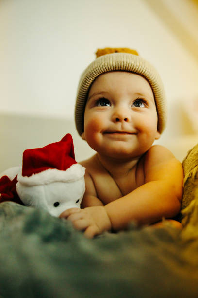 istock Cute baby lying in bed with teddy bear 2191853330