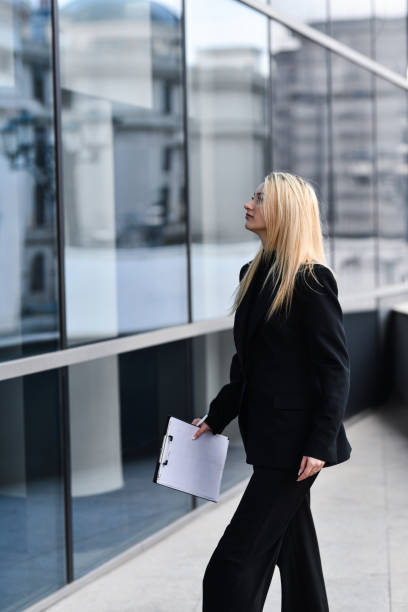 istock Professional Female Doing Safety Control Check Inspecting Building Exterior Taking Notes 2191853608