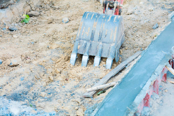 Shovel of small backhoe on sidewalk construction site and repairing in street Sukonthasawat in Bangkok Ladprao