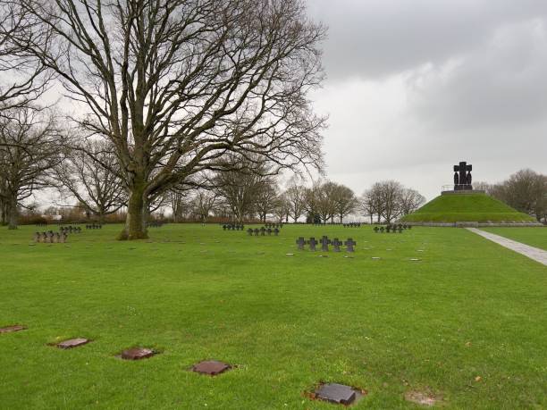 istock Grassy cemetery with black crosses and monument 2191853924