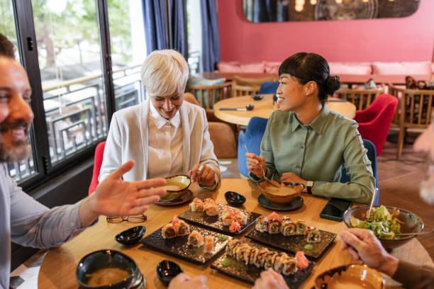 istock Business colleagues sharing a meal at a restaurant, engaging in conversation and building relationships 2191857211