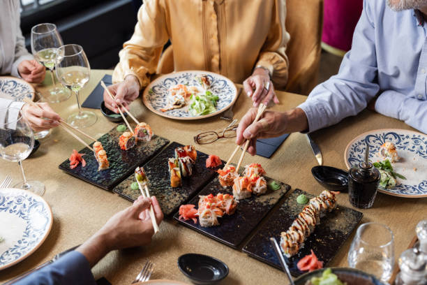 istock People enjoying a sushi meal with chopsticks at a restaurant 2191857250