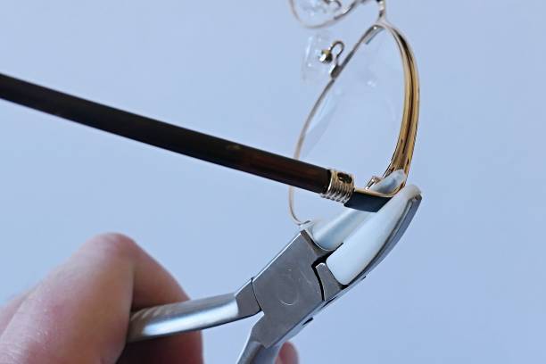 istock Adjusting inclination of temples on modern metal eyeglass frame with conical inclination pliers 2191859254