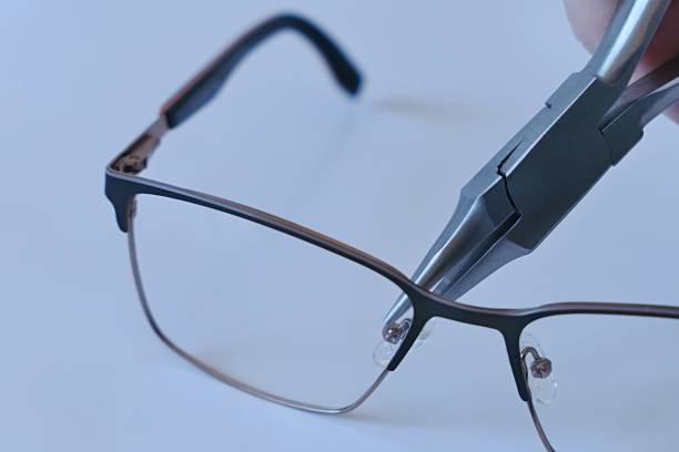 istock Adjusting nose pads on metal eyeglass frames with chain nose pliers 2191859272