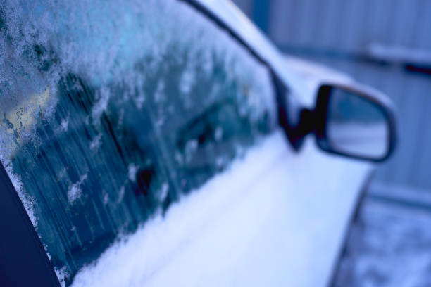 the white car is covered with ice and snow
