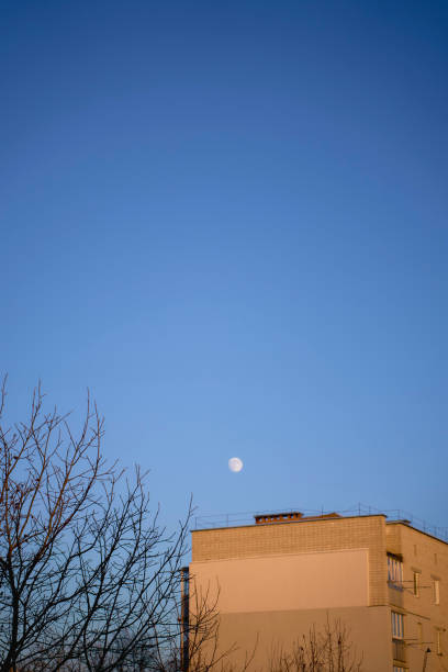 istock a full moon over paneled high-rise building at sunset 2191859538