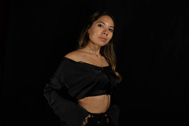 istock posing latina woman posing on camera with black background 2191861678