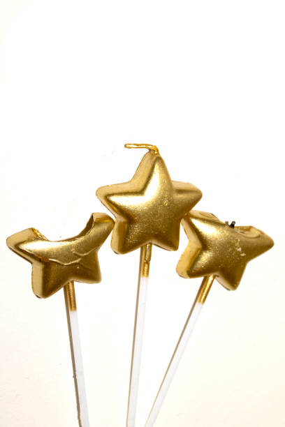 istock Party Over Gold Candle Star Shaped Melting On White Background Celebration 2191862459