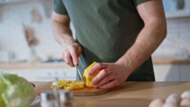 istock Cook hands slicing pepper on board home kitchen closeup. Woman making surprise 2191862620