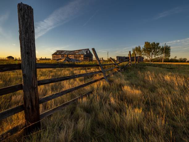 istock Rustic fence and barn at sunset in countryside. 2191864366