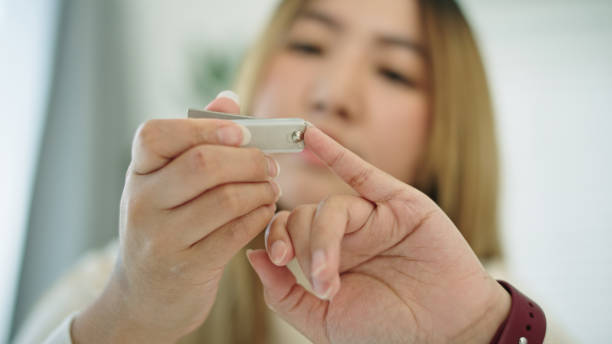 istock Woman cutting fingernail herself. 2191866047