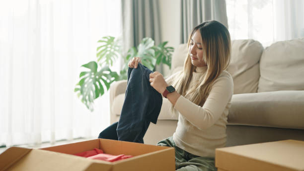 istock Woman packing clothes into donate box. 2191867647