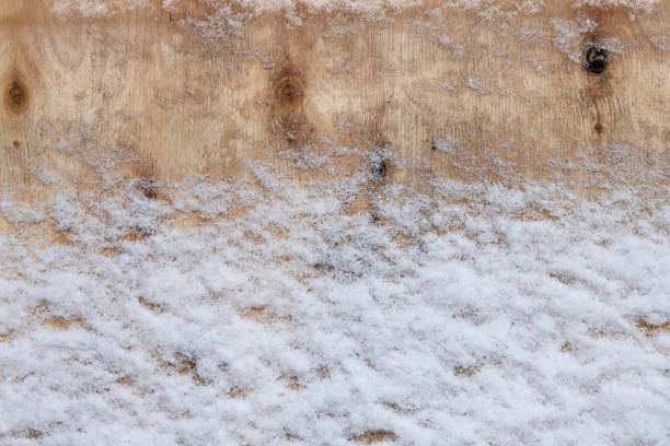 Wooden background covered with snow
