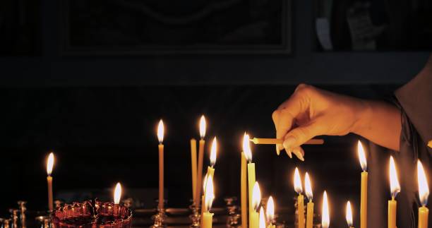 istock Lighting Candles Symbolizing Deep Faith and Spiritual Devotion in a Sacred Space Creates Atmosphere for Reflection and Connection With Higher Power, Enhancing Prayer and Ritual Experience 2191871982