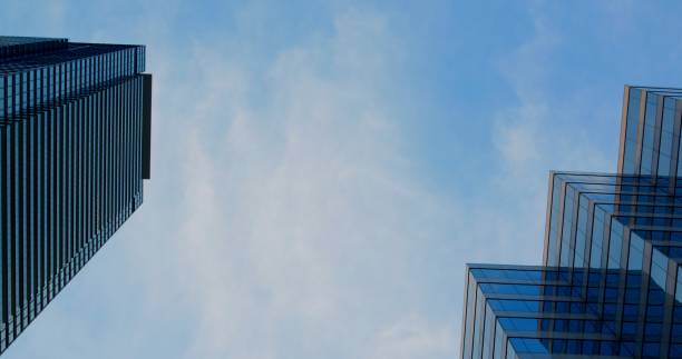istock Skyscrapers Stretching Upward Towards Blue Sky Reflecting Modern Architecture Capturing Urban Perspective With Stunning Vertical Designs In Cityscape Of Glass Structures And HighRise Buildings 2191872107