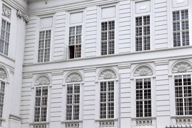 Historic White Facade with Ornate Details and Open Window, Perfect for Architecture Themes or Copy Space in Urban Travel Ads. High quality photo