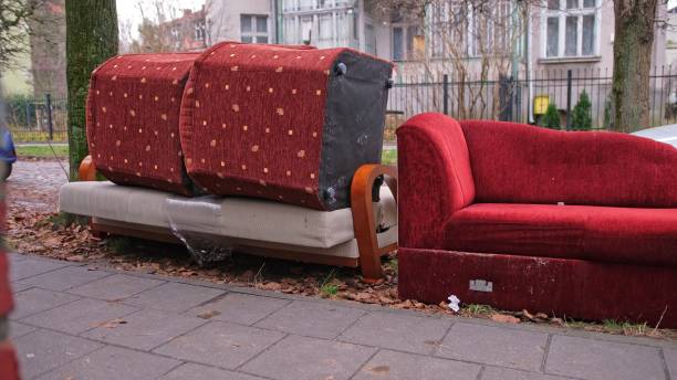 istock Old Unwanted Furniture Couch Dumped on Sidewalk on Bulk Garbage Collection Day for Curbside Pickup by City Cleaning Services 2191876137