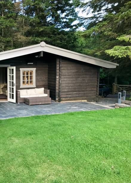 istock Wooden cabin in the woods with grass 2191882179