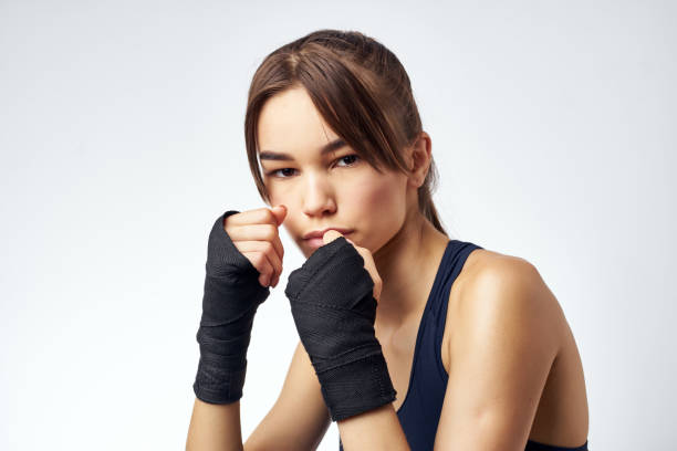 woman sporting boxing bandages rack kickboxing exercise. High quality photo
