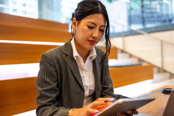 istock Businesswoman working on a tablet in a modern urban setting 2191890739