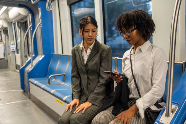 istock Two professional businesswomen commuting on a subway in Houston 2191890761