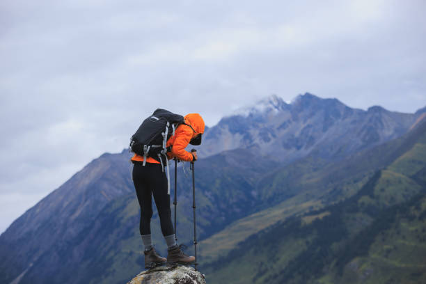 istock Woman backpacker hiking on high altitude mountain top 2191898195