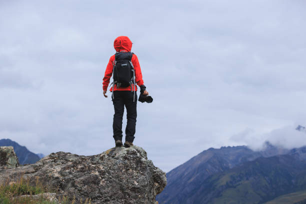 istock Successful hiker with camera on mountain top 2191898446