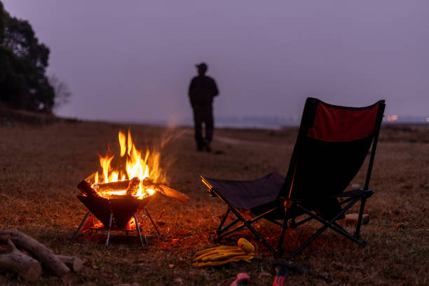 A Chinese man and a camping bonfire outdoors