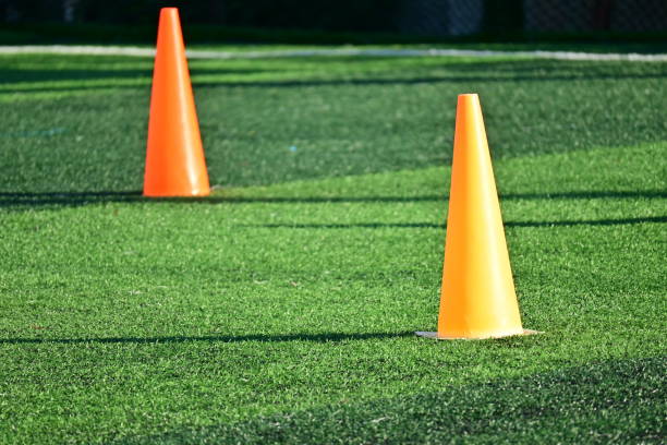 istock artificial green grass soccer field with orange training cones 2191905947