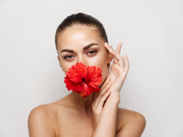 istock woman with bare shoulders red flower charm attractive look 2191911287